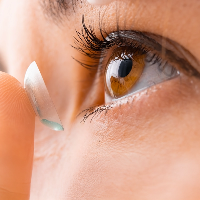 Contact lens about to be applied to eye